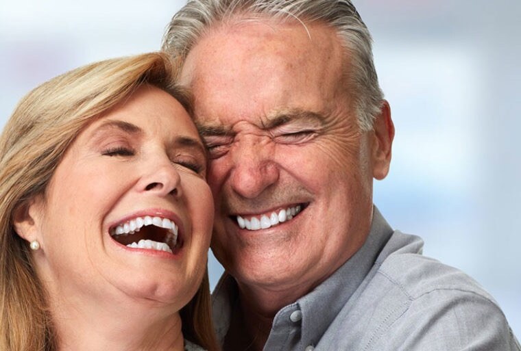 A couple laughing together, cheek to cheek