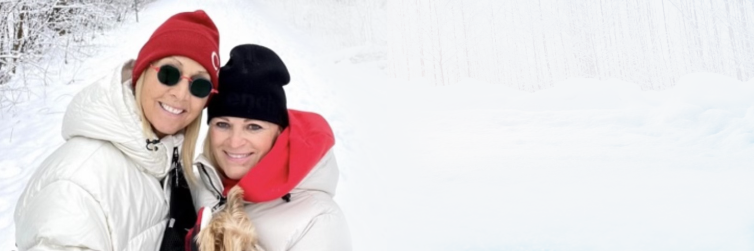 A couple bundled up together in winter, smiling